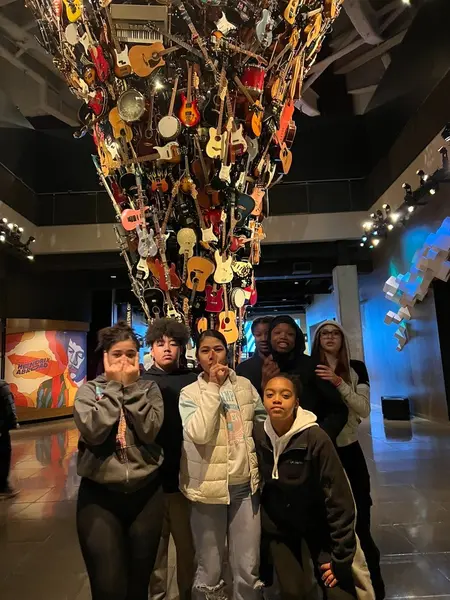Youth group posing in front of the giant guitar sculpture at MoPOP Seattle